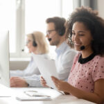 call center employee with headset in front of computer