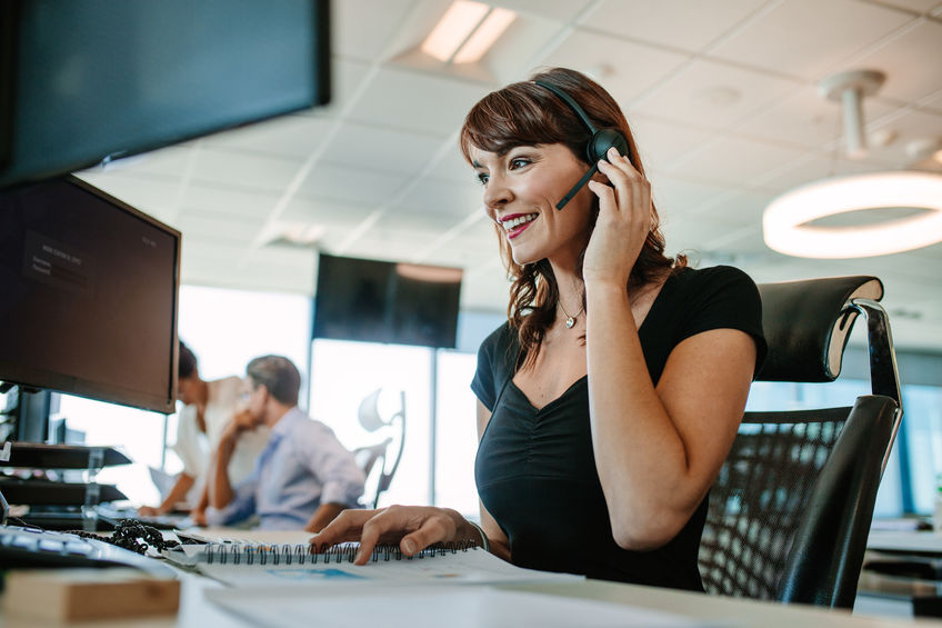 A female receptionist taking a call on her headset