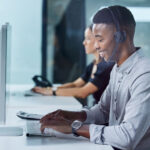 Shot of a young call center agent typing in an office.